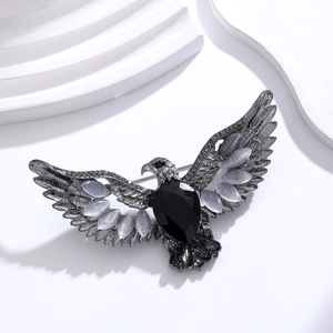 Detail of vintage eagle brooch with black teardrop gem and grey rhinestones