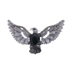 Detailed macro view of eagle brooch with black stone and grey opal wing accents