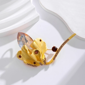 Vintage gold petal brooch with amber water drop stone and brushed metal details