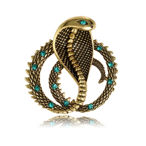 Retro golden cobra snake brooch with green rhinestones on white background