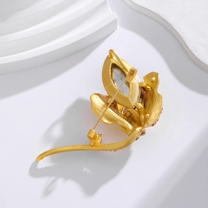 Vintage golden flower brooch with purple crystals and brushed metal back detail