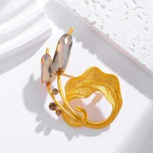 Vintage gold petal brooch with amber gemstones and detailed leaf texture shown from 45-degree angle
