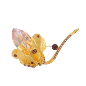Vintage gold ginkgo leaf brooch with teardrop purple crystal and colorful rhinestones