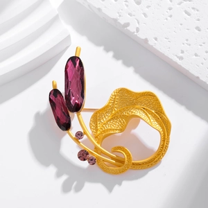 Vintage gold petal butterfly brooch with purple gems on white geometric background