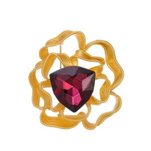 Vintage camellia brooch featuring a dark red triangular glass gemstone and golden frame