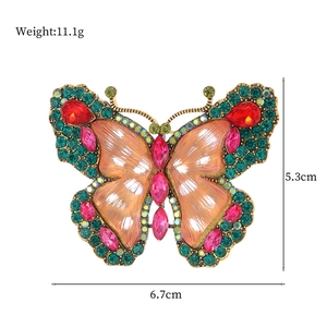 Vintage butterfly brooch with orange wings and colorful rhinestones, 6.7cm x 5.3cm