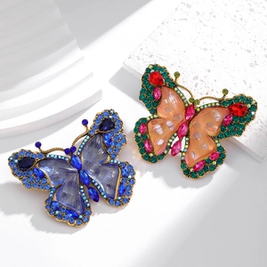 Macro detail of vintage butterfly brooches with colorful rhinestones and metal textures