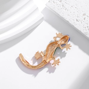 Exquisite gold-plated enamel lizard brooch with safety pin back view on stone base