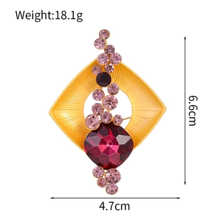 Luxurious gold-tone geometric crystal brooch with purple rhinestones and red center gem