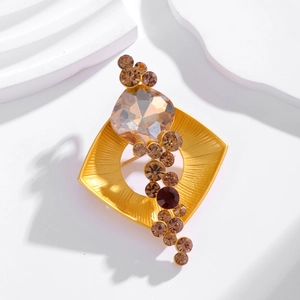 Elegant geometric square crystal brooch with gold brushed metal frame on white pedestal