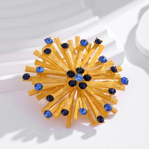 Vintage gold sunflower brooch with blue crystals on an elegant white background