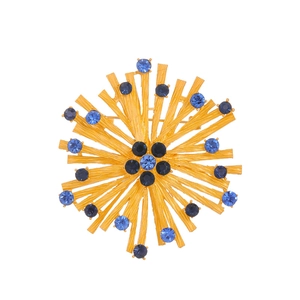 Vintage gold snowflake brooch with blue rhinestones in a sunburst design