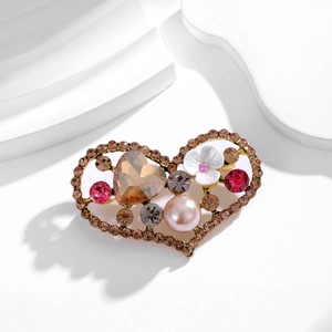 Elegant hollow heart brooch with pearl, champagne crystal and floral accents in gold finish