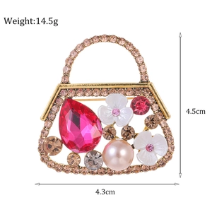 Vintage gouden handtas broche met roze edelsteen en sprankelende diamanten