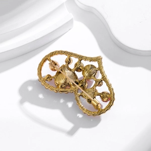Vintage heart brooch with mother of pearl and colorful diamonds on golden filigree base