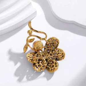 Vintage floral brooch with gold metal texture, rhinestones and purple pearl accent