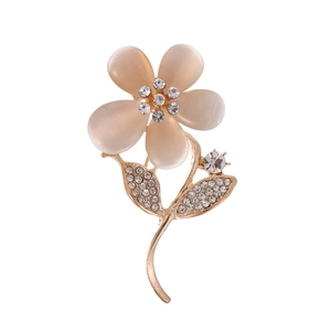 Elegant gold flower brooch with cat eye stone petals and sparkling rhinestone accents