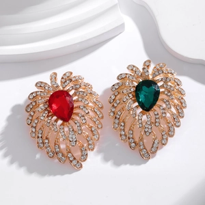 Macro detail of luxury vintage brooch with emerald and ruby teardrop crystals