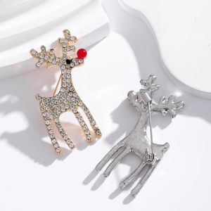 Elegant reindeer Christmas brooch with sparkling rhinestones and red nose on white background