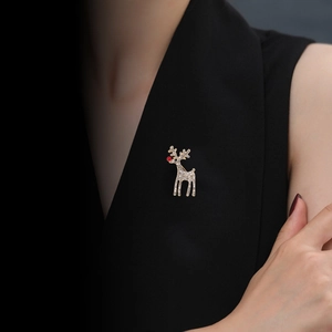 Detailed view of a sparkling rhinestone reindeer brooch pinned on a black garment