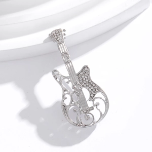 Vintage silver guitar brooch with white crystal pavé and intricate hollow patterns