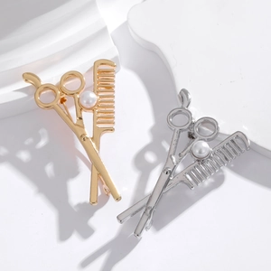 Barber scissor and comb brooches in gold and silver finish with pearl detail on white steps