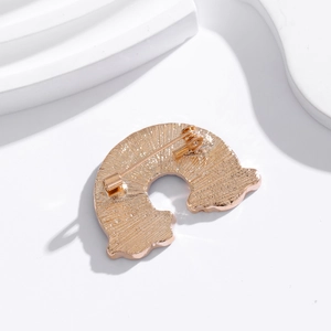 Back view of cute rainbow brooch in rose gold with brushed texture and safety pin