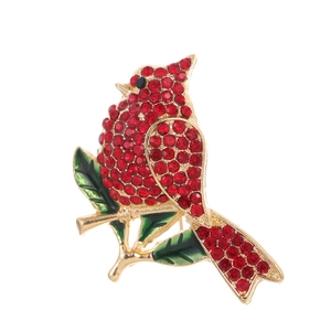 Vintage cardinal bird brooch with red rhinestones and green enamel leaves on gold base