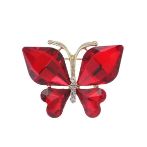Makroaufnahme der roten Kristall-Schmetterlingsbrosche mit goldenem Rahmen und Strass