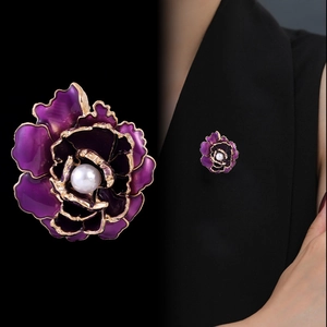 Elegant purple peony brooch with gold trim and pearl center on black suit lapel