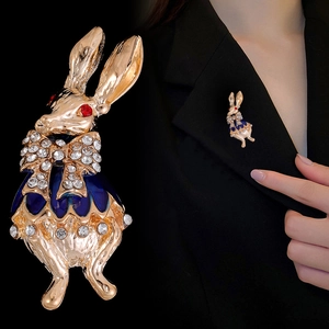 Vintage enamel rabbit brooch with red rhinestones and bow on a black blazer
