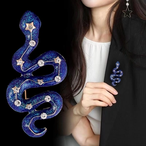 Vintage navy blue snake brooch with starry pattern and gold stars on black suit