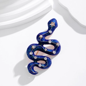 Vintage navy blue snake brooch with starry glitter finish and rhinestones on white display