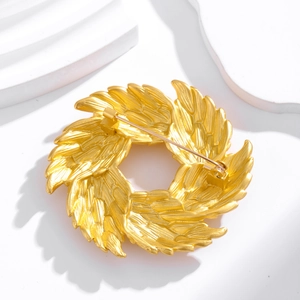 Vintage golden olive branch wreath brooch with matte finish and detailed feather texture