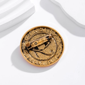 Gold Eye of Horus brooch back detail with secure pin clasp on minimalist stone display
