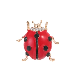 Fashionable ladybug brooch with red enamel and sparkling black crystals on gold plating