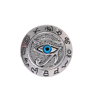 Detailed view of antique silver Horus Eye brooch with engraved Egyptian symbols