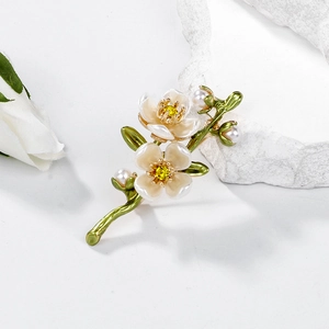 Romantic floral brooch with green leaves, cream petals and white pearls on stone