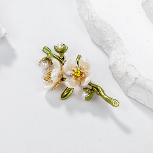 Romantic floral branch brooch with white petals, yellow crystal, and pearls on white stone