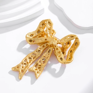 Back view of a gold vintage rhinestone bow brooch featuring a secure pin clasp closure