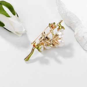 Elegant green enamel jasmine flower brooch with white pearls on a gold metal base