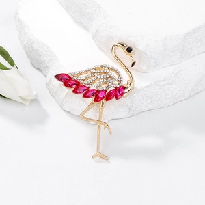 Elegant flamingo brooch with pink crystals and white rhinestones on a gold base