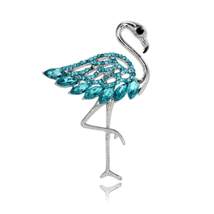 Detailed view of silver flamingo brooch with blue crystals and marquise-cut gems