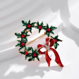 Christmas wreath brooch with green holly leaves, red enamel bow and sparkling rhinestones