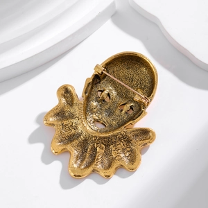 Vintage bronze clown face brooch with retro textured finish and secure pin clasp backing