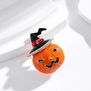 Retro Halloween pumpkin brooch with wizard hat and rhinestones on white display