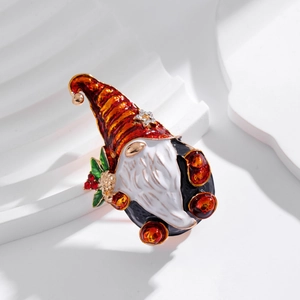 Christmas gnome brooch with red hat and star rhinestone on white geometric display