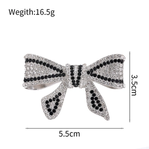 Sparkling black and white rhinestone bow brooch with silver base and elegant crystal inlay
