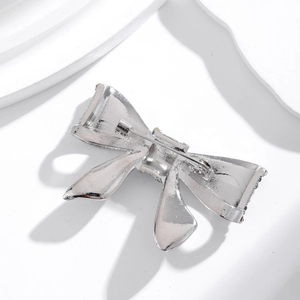 Elegant silver bow brooch with pearls and crystals shown from the back with secure pin