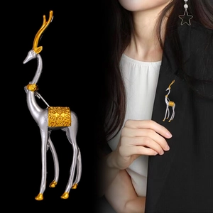Elegant silver and gold elk brooch pinned on a black suit jacket for a vintage luxury look